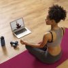 full-shot-woman-sitting-virtual-welness-yoga-mat